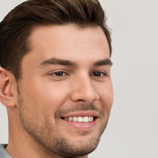 Joyful white young-adult male with short  brown hair and brown eyes