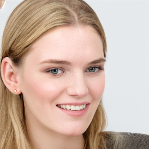 Joyful white young-adult female with long  brown hair and blue eyes