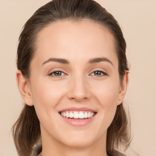 Joyful white young-adult female with long  brown hair and brown eyes