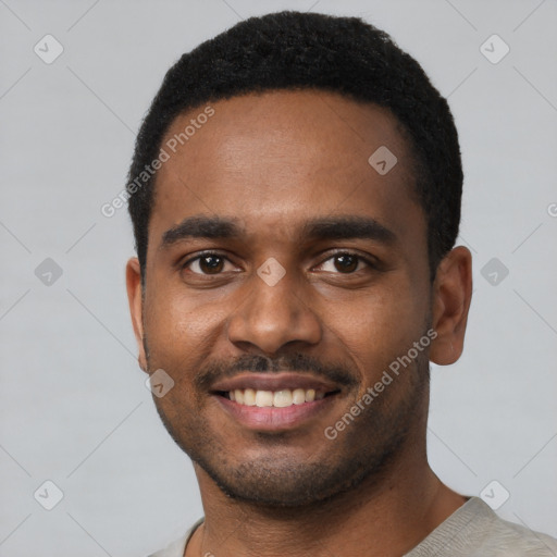 Joyful black young-adult male with short  black hair and brown eyes