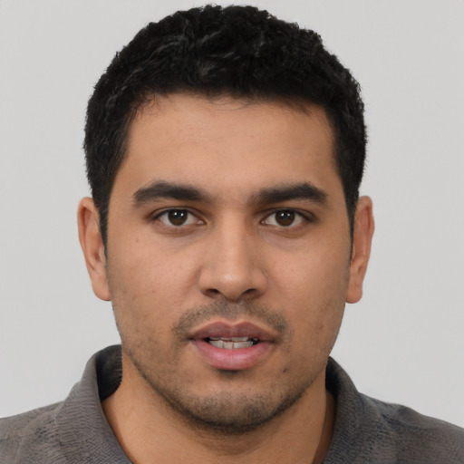 Neutral latino young-adult male with short  black hair and brown eyes