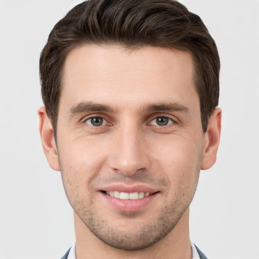 Joyful white young-adult male with short  brown hair and brown eyes