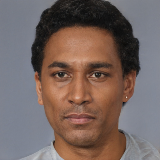 Neutral latino adult male with short  black hair and brown eyes