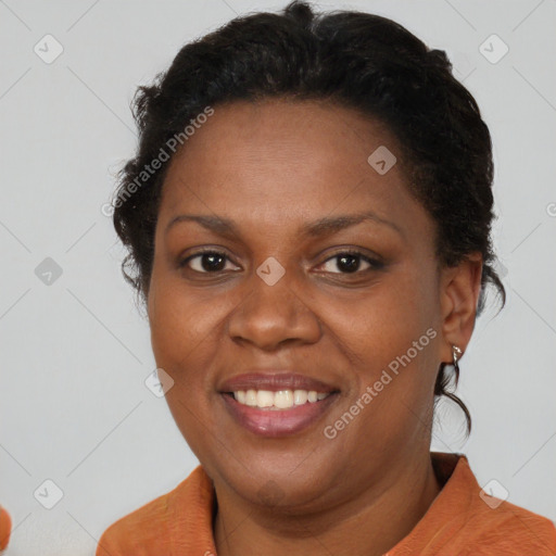 Joyful black adult female with short  brown hair and brown eyes