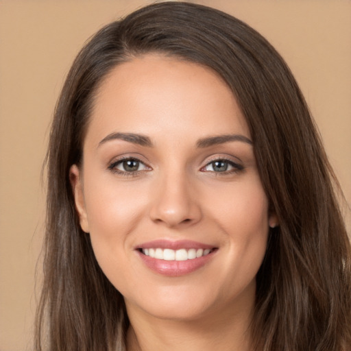 Joyful white young-adult female with long  brown hair and brown eyes