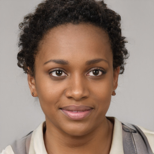 Joyful black young-adult female with short  brown hair and brown eyes