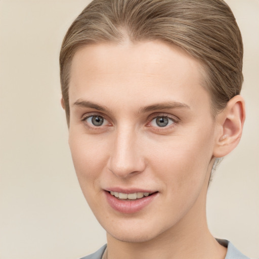 Joyful white young-adult female with short  brown hair and grey eyes