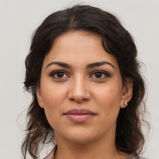 Joyful latino young-adult female with long  brown hair and brown eyes