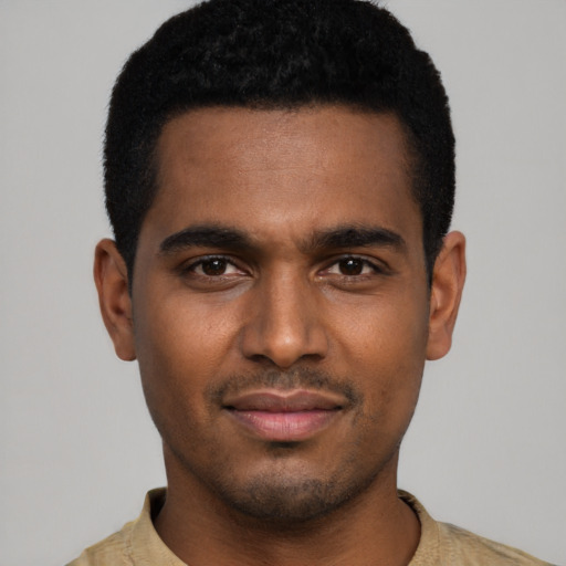 Joyful black young-adult male with short  black hair and brown eyes