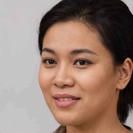 Joyful asian young-adult female with medium  brown hair and brown eyes