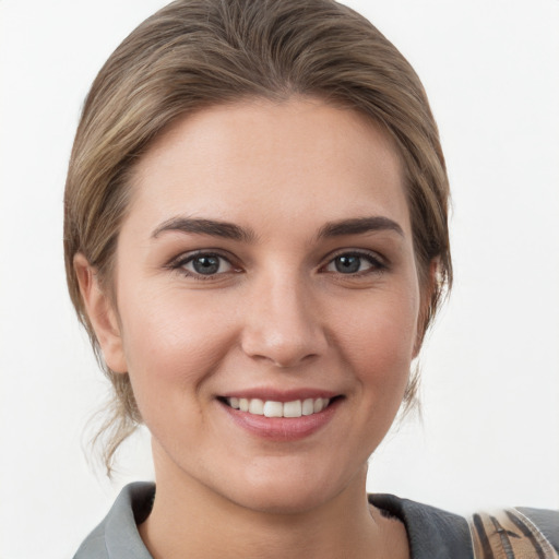 Joyful white young-adult female with medium  brown hair and grey eyes