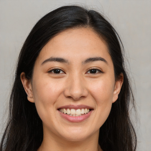 Joyful white young-adult female with long  brown hair and brown eyes