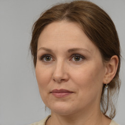 Joyful white adult female with medium  brown hair and grey eyes