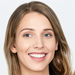 Joyful white young-adult female with long  brown hair and green eyes