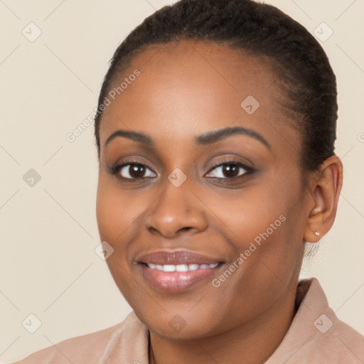 Joyful black young-adult female with short  brown hair and brown eyes