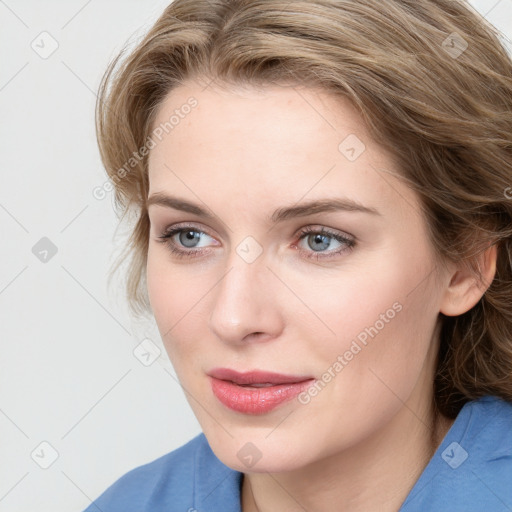 Joyful white young-adult female with medium  brown hair and blue eyes