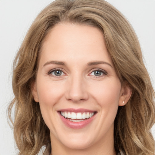 Joyful white young-adult female with long  brown hair and green eyes