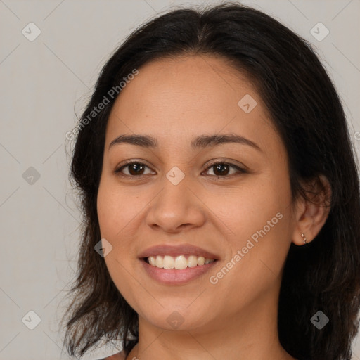 Joyful latino young-adult female with medium  brown hair and brown eyes