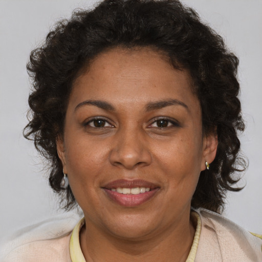 Joyful black adult female with short  brown hair and brown eyes