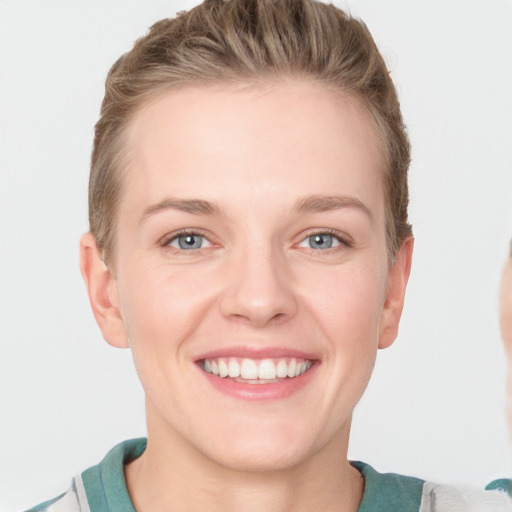 Joyful white young-adult female with short  brown hair and blue eyes