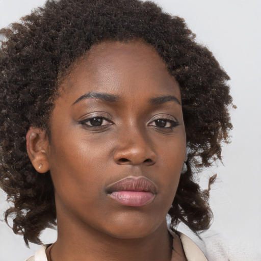 Neutral black young-adult female with medium  brown hair and brown eyes