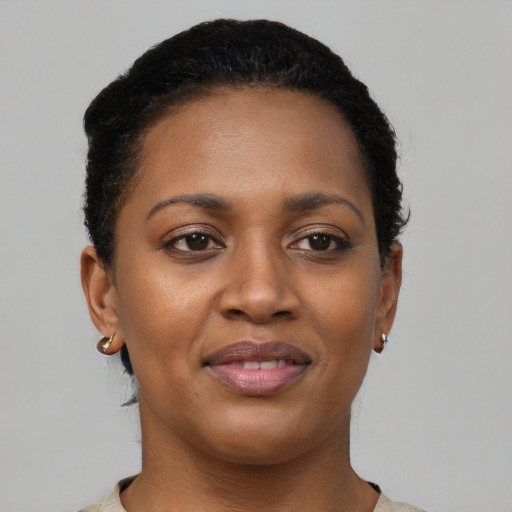 Joyful black young-adult female with short  brown hair and brown eyes