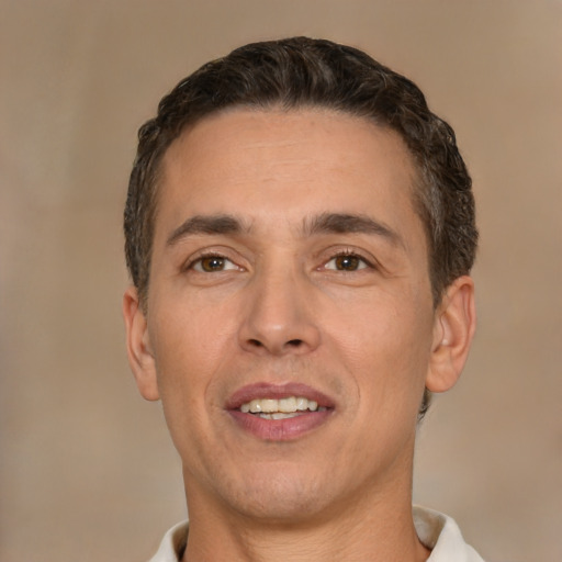 Joyful white adult male with short  brown hair and brown eyes