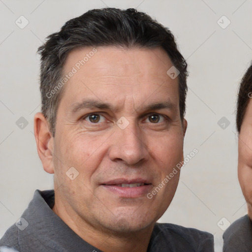 Joyful white adult male with short  brown hair and brown eyes