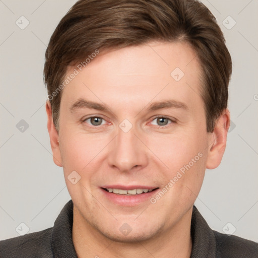 Joyful white young-adult male with short  brown hair and grey eyes