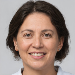 Joyful white adult female with medium  brown hair and brown eyes