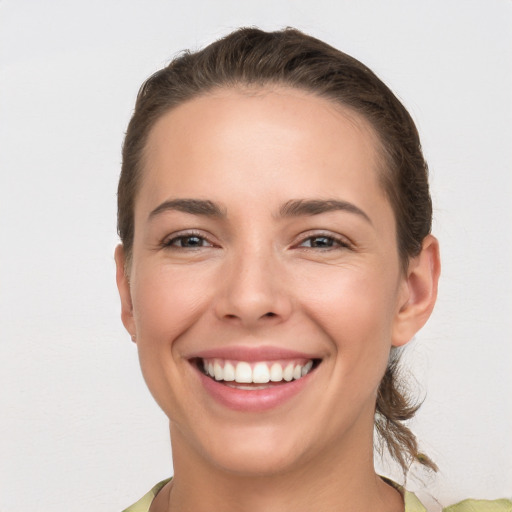 Joyful white young-adult female with short  brown hair and brown eyes