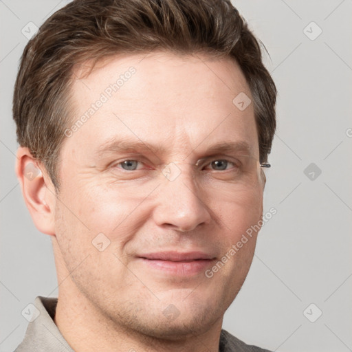 Joyful white adult male with short  brown hair and grey eyes