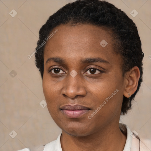 Joyful black young-adult female with short  black hair and brown eyes