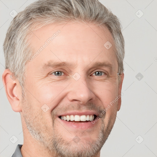 Joyful white adult male with short  brown hair and grey eyes