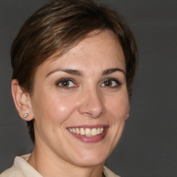 Joyful white young-adult female with medium  brown hair and brown eyes