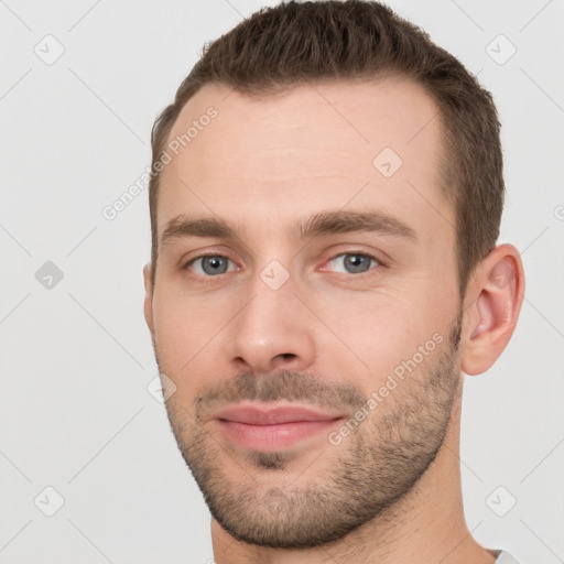 Joyful white young-adult male with short  brown hair and brown eyes