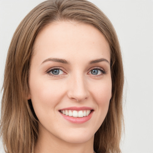 Joyful white young-adult female with long  brown hair and green eyes