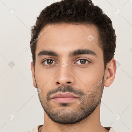 Neutral white young-adult male with short  black hair and brown eyes