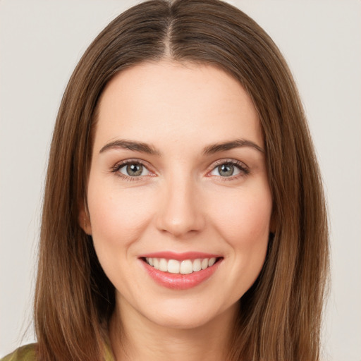 Joyful white young-adult female with long  brown hair and brown eyes