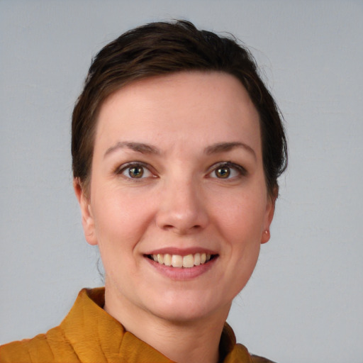 Joyful white young-adult female with short  brown hair and grey eyes