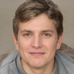 Joyful white adult male with short  brown hair and grey eyes