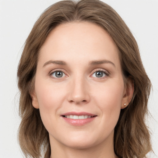 Joyful white young-adult female with long  brown hair and grey eyes