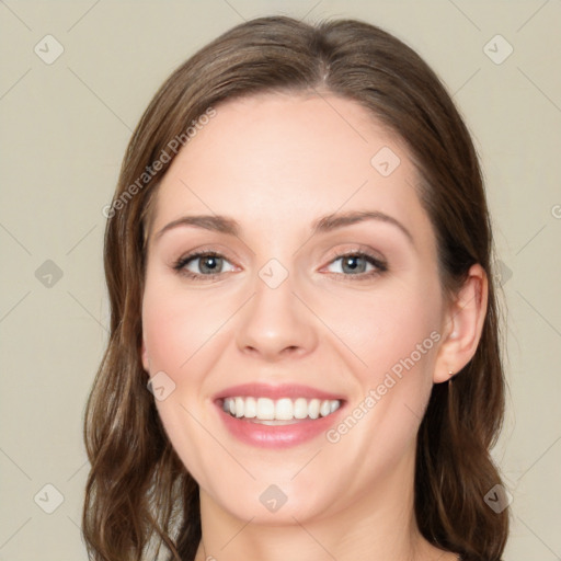 Joyful white young-adult female with medium  brown hair and green eyes