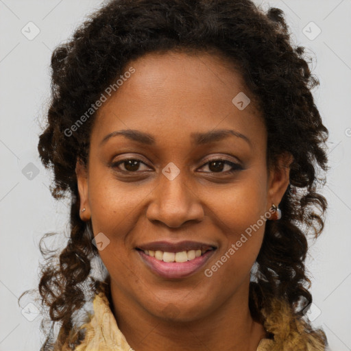 Joyful black young-adult female with long  brown hair and brown eyes