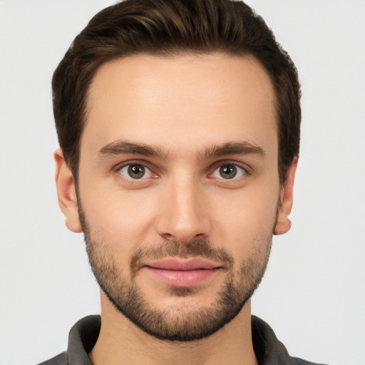 Joyful white young-adult male with short  brown hair and brown eyes