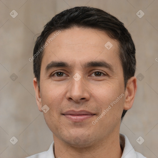 Joyful white adult male with short  black hair and brown eyes