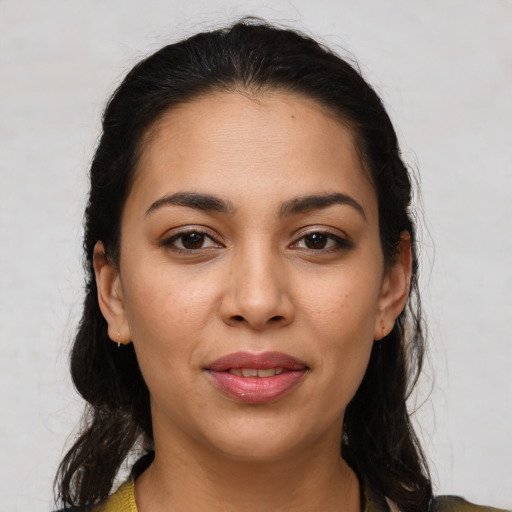 Joyful latino young-adult female with medium  brown hair and brown eyes