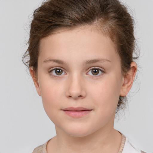 Joyful white child female with short  brown hair and brown eyes