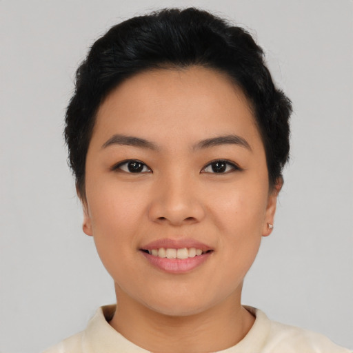 Joyful asian young-adult female with short  black hair and brown eyes