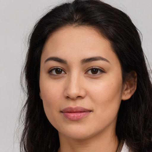 Joyful white young-adult female with long  brown hair and brown eyes